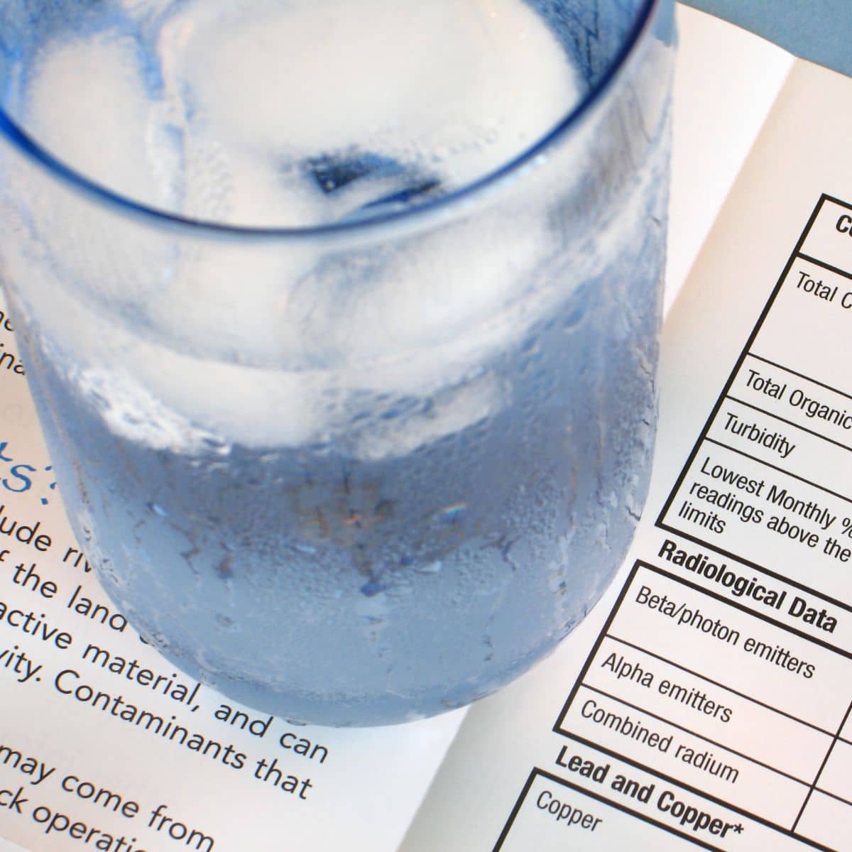 How to test for lead in water, water sample next to a lab quality report