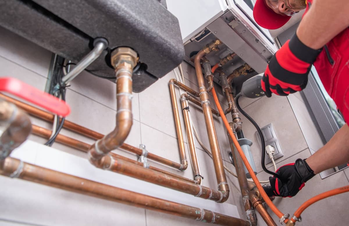 Plumber working on replacement plumbing for an older home